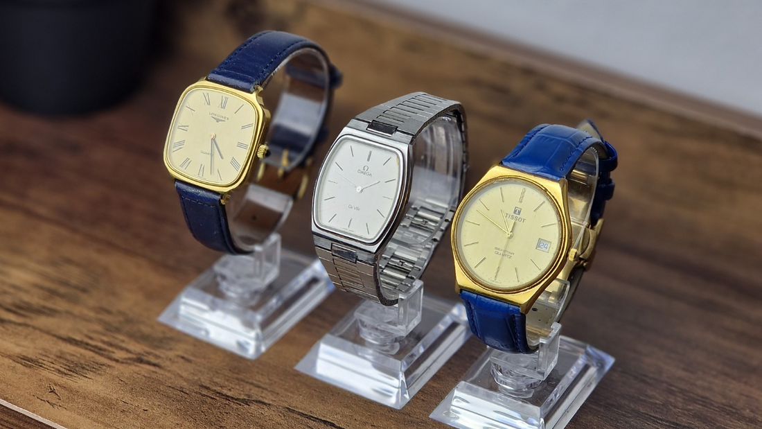 Three Men’s Vintage Watches lineup pointing left: a classic Longines Tank, an elegant Omega Vintage Watch De Ville, and a stylish Tissot Seastar from vintage collections.