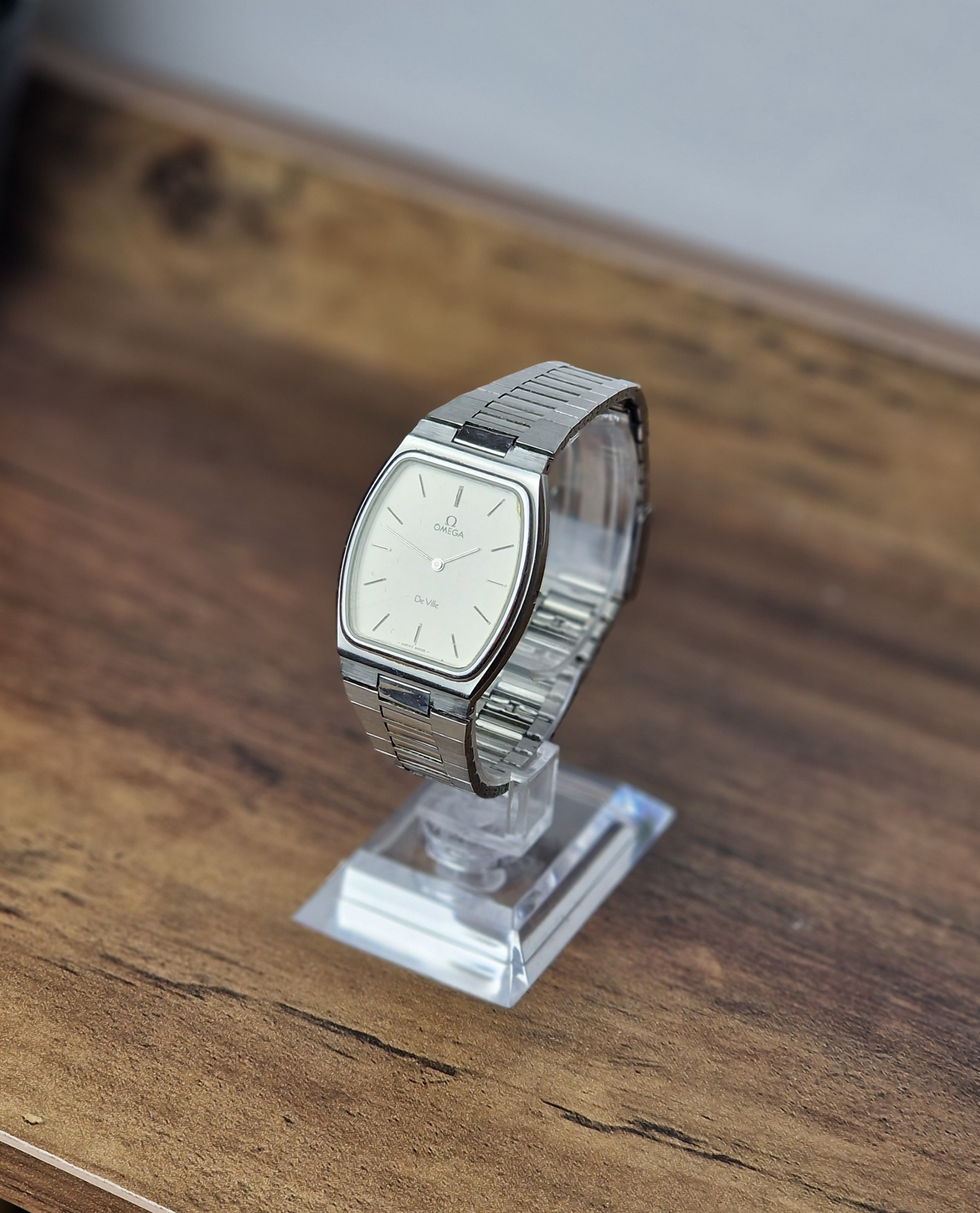 Vintage Omega De Ville Tank watch with a classic rectangular gold-tone case and elegant dress dial, showcasing Swiss craftsmanship and timeless sophistication.