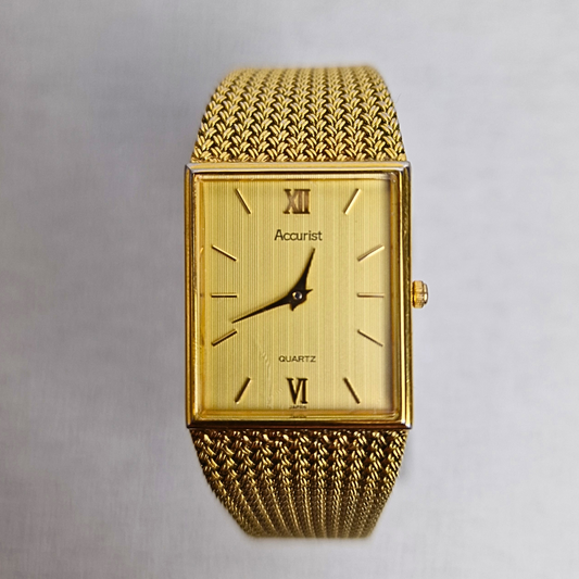 Men's vintage Accurist gold-plated tank watch with striped gold dial and quartz movement.