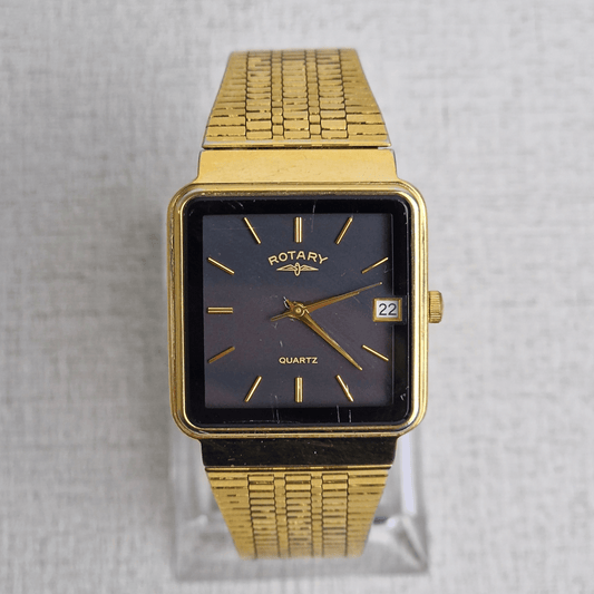 Mens Rotary Tank Watch Ref. 3815 with square gold-plated case, black dial, integrated bracelet, and date window at 3 o’clock.
