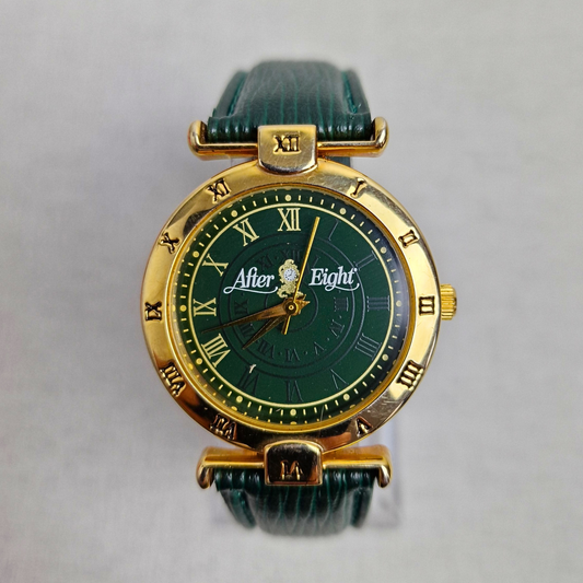 Vintage men's After Eight watch with green Roman numeral dial, gold-plated case, and green leather strap with gold clasp.